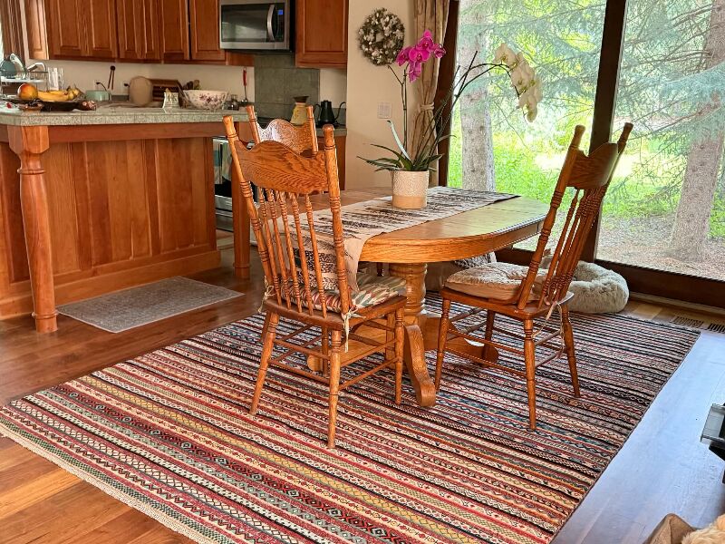 Even better in person! I was looking for a wool rug to replace a beige synthetic rug we had for years. I found so many beautiful rugs at Rug Source that it was very hard to choose. However, I decided to go for a simple design because I thought that it would be a shame to hide an intricate Persian rug under a table. This wool rug is beautifully made. I love the different design patterns within the stripes. The colors are warm and cheerful; perfect for the dining room. The shipping was very speedy and the packaging was fantastic. I would recommend Rug Source in a heartbeat to anyone who wants to find a one of a kind rug, and rugs that come with a history!